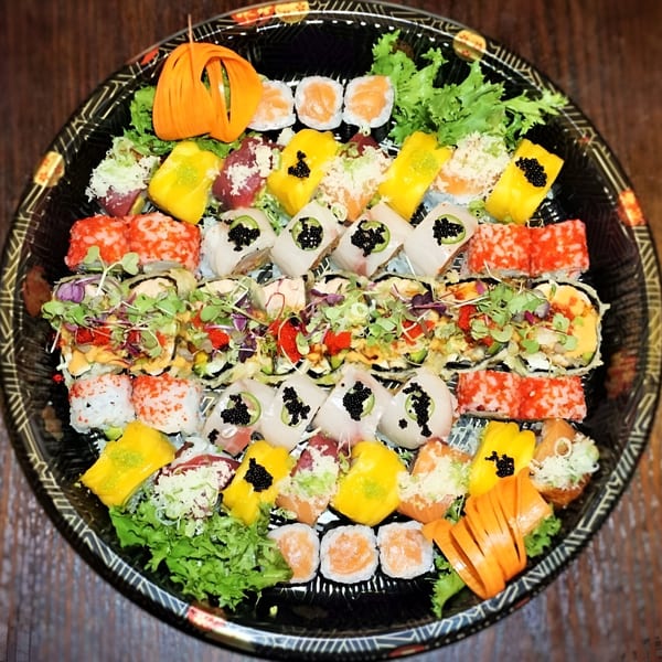 A large platter of Tsuru Sushi Asian Cuisine's colorful sushi rolls, nigiri, and sashimi.